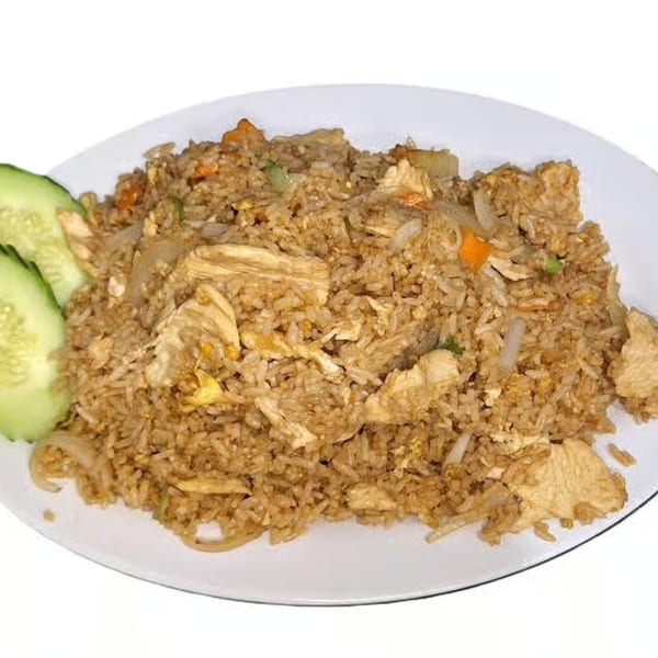 Hoshi Japanese Steakhouse's chicken fried rice with vegetables and cucumber slices on a white plate.