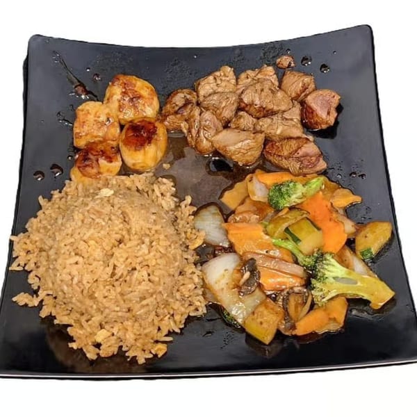 Hoshi Japanese Steakhouse hibachi plate with steak, scallops, fried rice, and mixed vegetables.